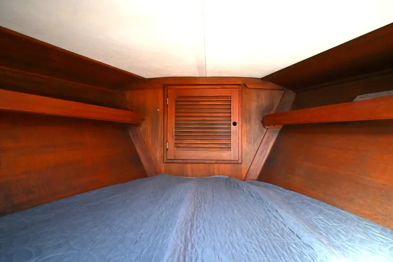 Slide: The Image of Interior cabin of a 1980 Tartan 37 sailboat with wooden shelves and a bed. - 48