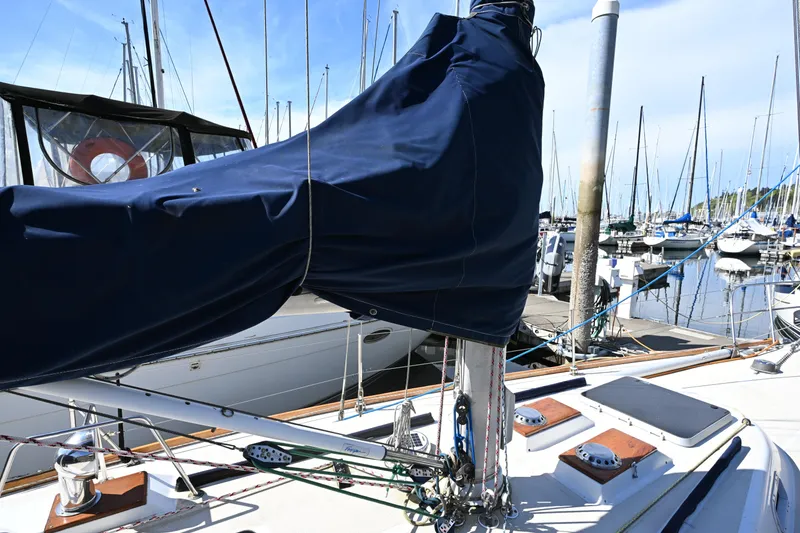 Slide: The Image of 1980 Tartan 37 sailboat mast and rigging at marina, covered in blue canvas. - 15