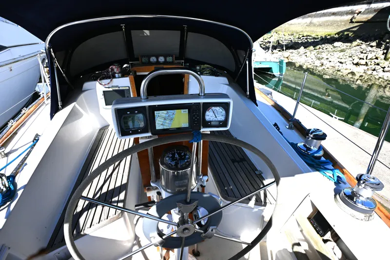 Slide: The Image of Cockpit of 1980 Tartan 37 sailboat with navigation instruments and steering wheel. - 21