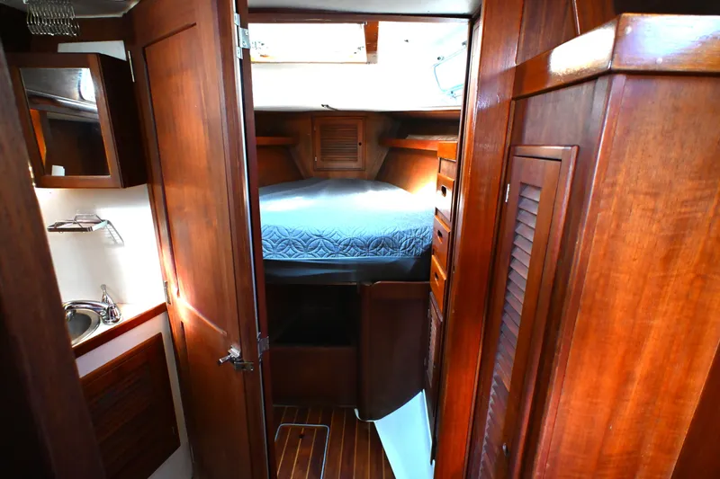 Slide: The Image of Interior of 1980 Tartan 37 sailboat with wooden cabinetry and cozy sleeping quarters. - 45