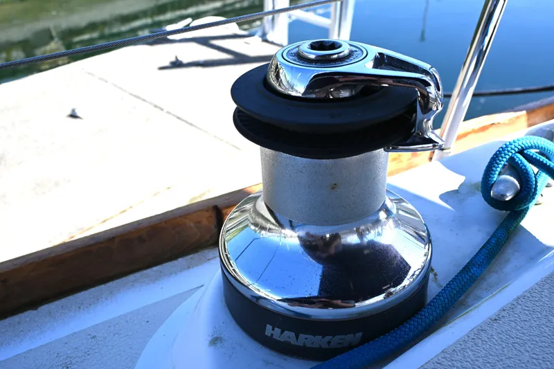 Slide: The Image of Chrome winch on 1980 Tartan 37 sailboat with blue rope, dockside view. - 26