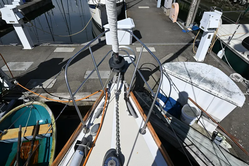 Slide: The Image of Bow of 1980 Tartan 37 sailboat docked at marina with visible anchor chain. - 7