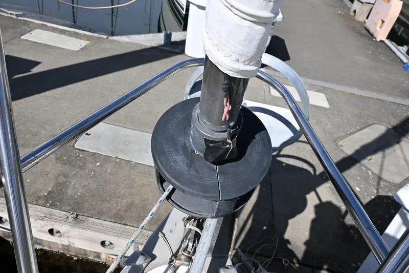 Slide: The Image of Deck view of a 1980 Tartan 37 sailboat with furling system and dock background. - 6
