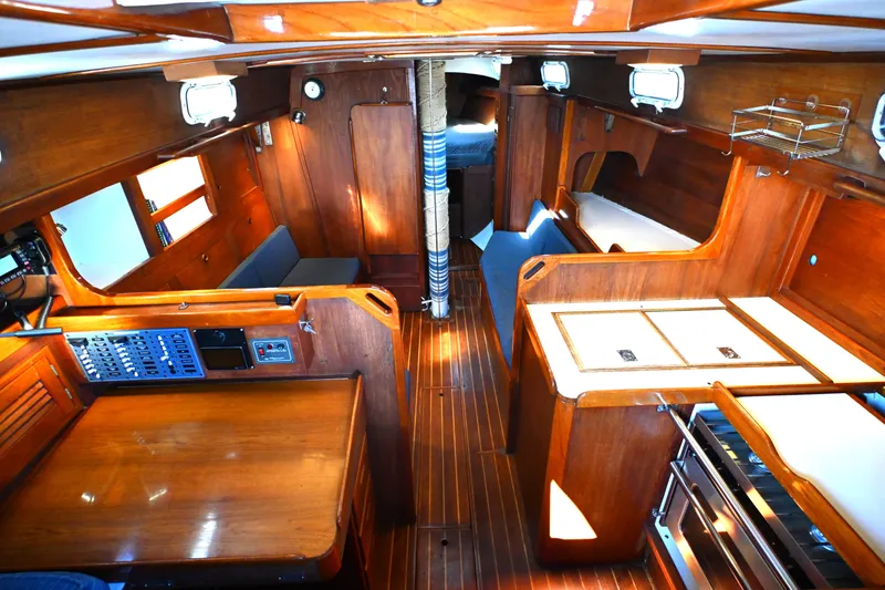 Slide: The Image of Interior of a 1980 Tartan 37 sailboat with wooden furnishings and cozy layout. - 30