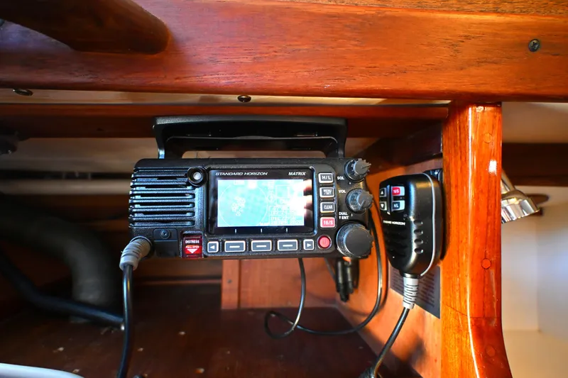 Slide: The Image of Marine radio equipment inside a 1980 Tartan 37 sailboat, featuring a Standard Horizon device. - 40