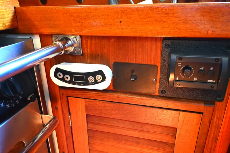 Slide: The Image of Control panel on a 1980 Tartan 37 sailboat with wooden cabinetry. - 35