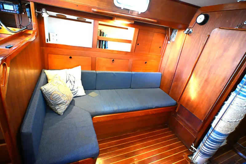 Slide: The Image of Cozy interior of 1980 Tartan 37 sailboat with wooden paneling and blue seating. - 41