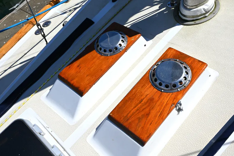 Slide: The Image of Deck details of a 1980 Tartan 37 sailboat with polished wood and metal fittings. - 10