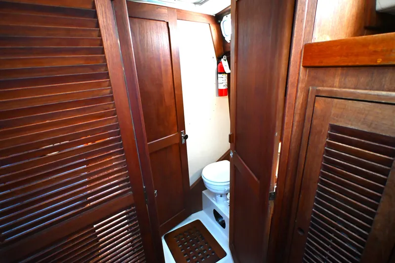 Slide: The Image of Wooden interior of 1980 Tartan 37 sailboat bathroom with toilet and fire extinguisher. - 50