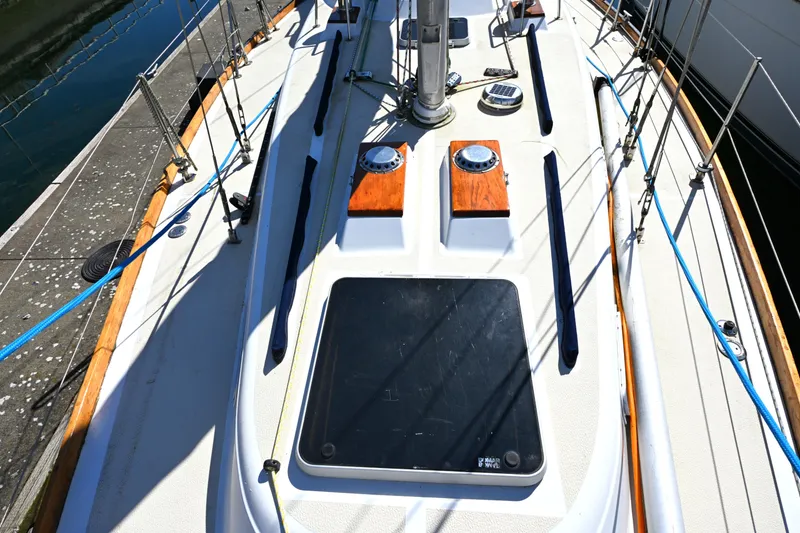Slide: The Image of 1980 Tartan 37 sailboat deck with wooden accents and rigging details. - 9