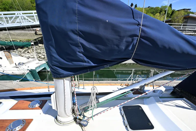 Slide: The Image of 1980 Tartan 37 sailboat deck with covered mast and rigging at marina. - 13
