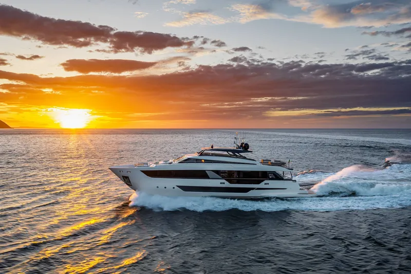 Slide: The Image of 2027 Ferretti Yachts 1000 cruising at sunset on the ocean. - 8