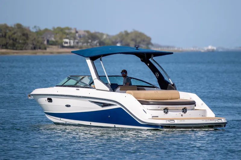 Slide: The Image of 2022 Sea Ray SLX 280 boat cruising on a calm blue lake. - 11