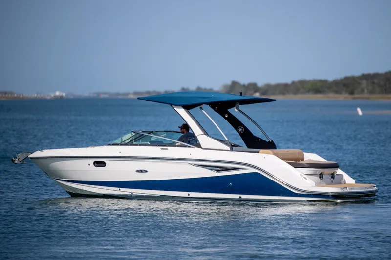 Slide: The Image of 2022 Sea Ray SLX 280 boat cruising on calm blue waters. - 2