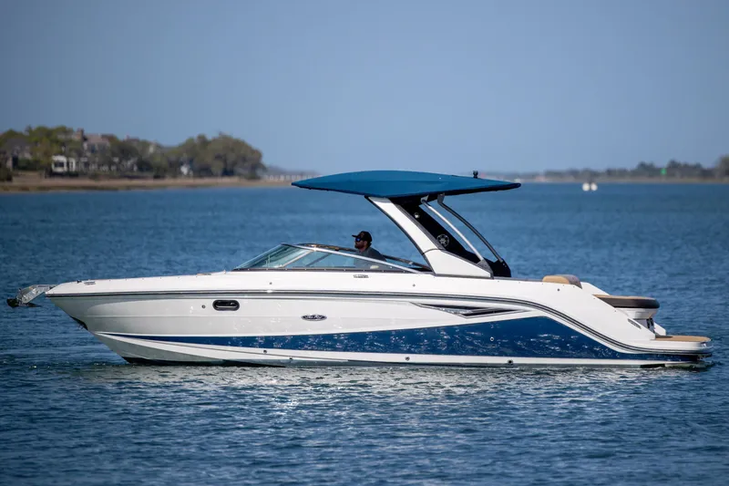 Slide: The Image of 2022 Sea Ray SLX 280 boat cruising on calm blue waters. - 9