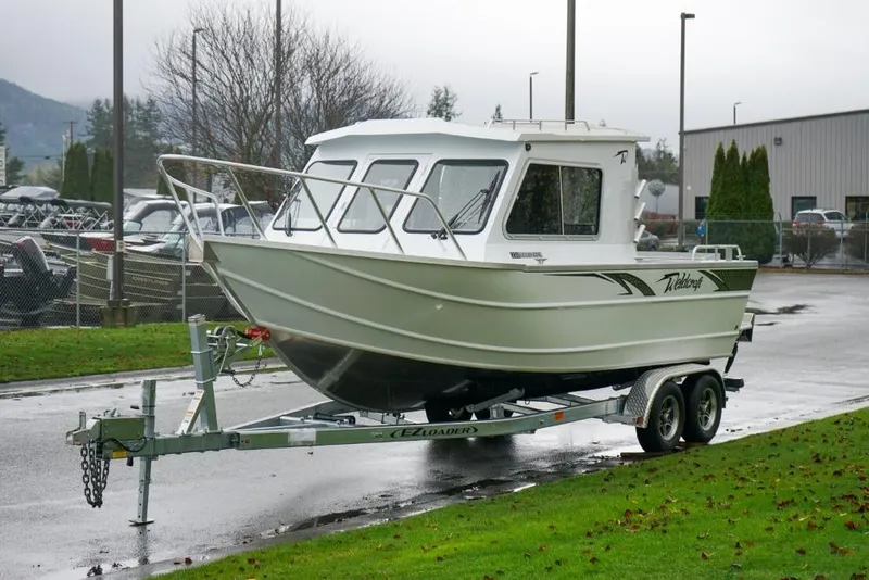 The Image of 2026 Weldcraft 220 Ocean King boat on trailer, parked outdoors on a rainy day. - 1