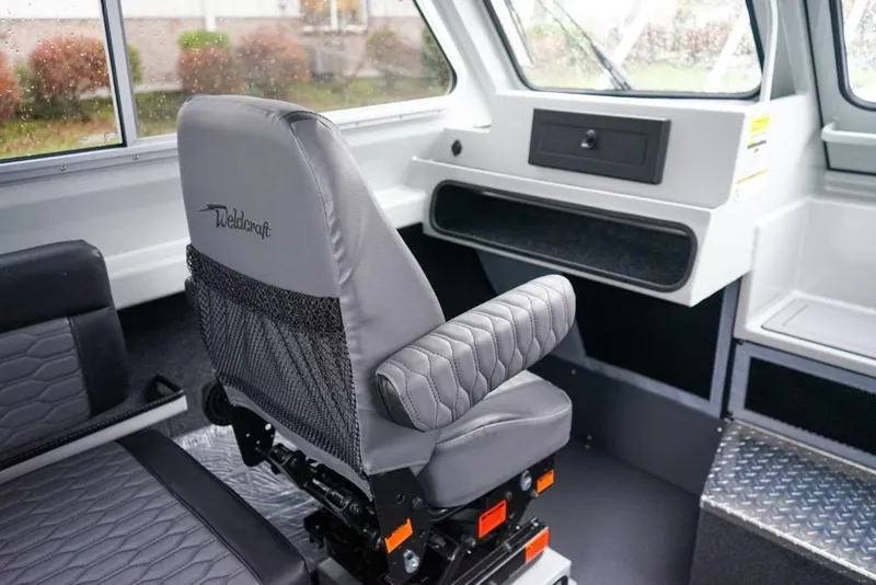 Slide: The Image of Interior of 2026 Weldcraft 220 Ocean King boat with gray seating and dashboard. - 14