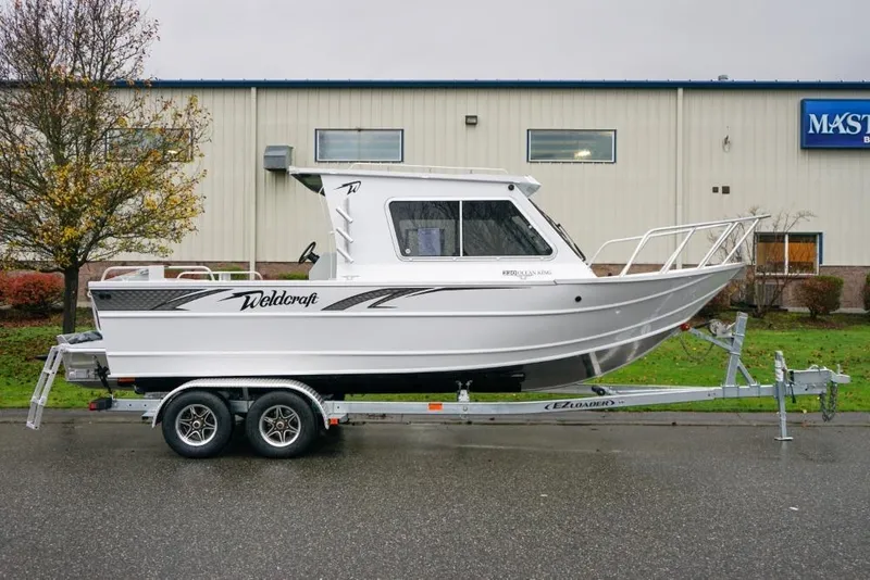 Slide: The Image of 2026 Weldcraft 220 Ocean King boat on trailer, parked outdoors. - 3