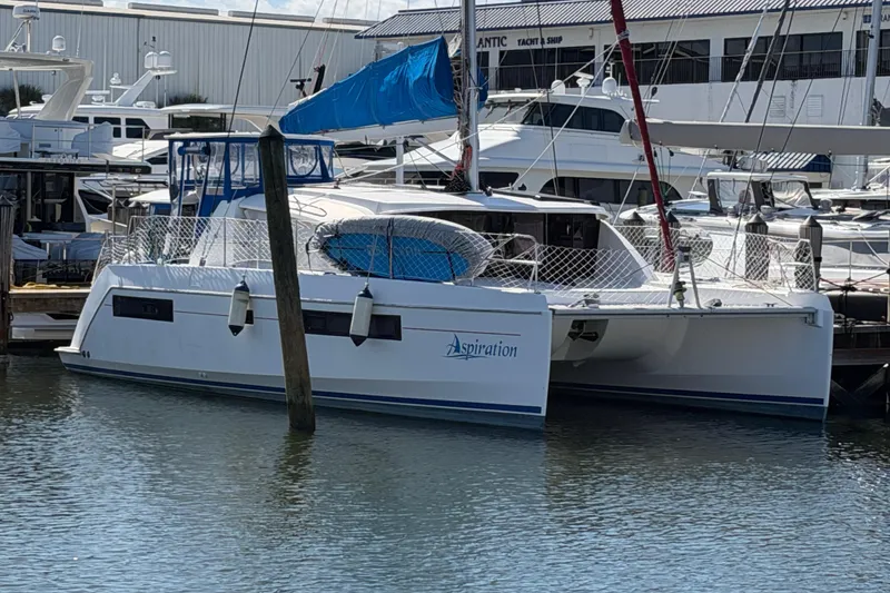 The Image of 2017 Leopard 40 catamaran docked at marina with blue sail cover. - 0