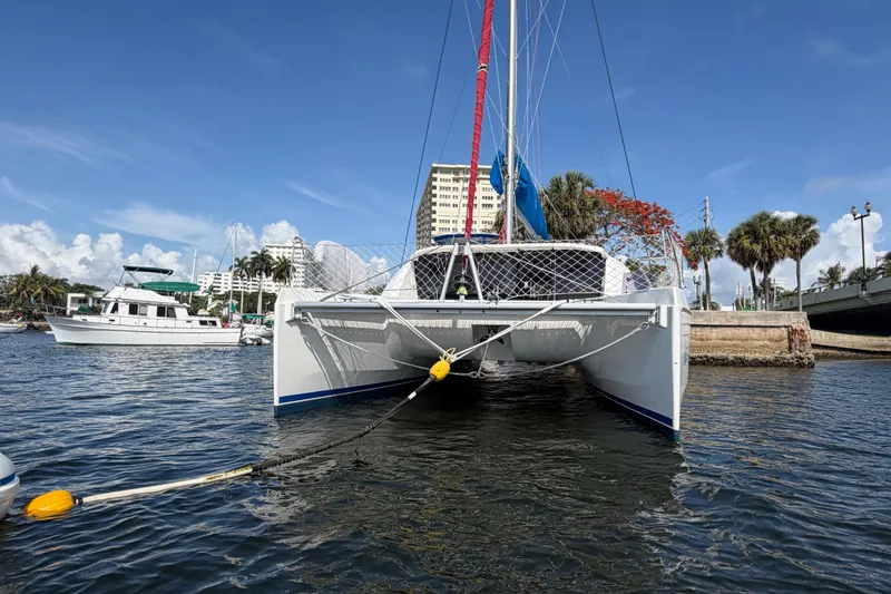 Slide: The Image of 2017 Leopard 40 catamaran docked in a sunny marina, surrounded by palm trees and buildings. - 11