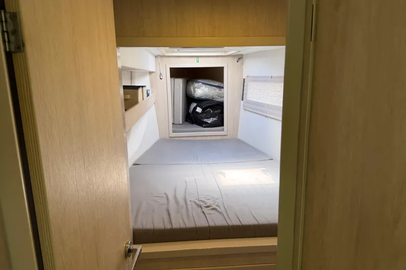 Slide: The Image of Interior cabin of a 2017 Leopard 40 catamaran with a bed and storage space. - 110