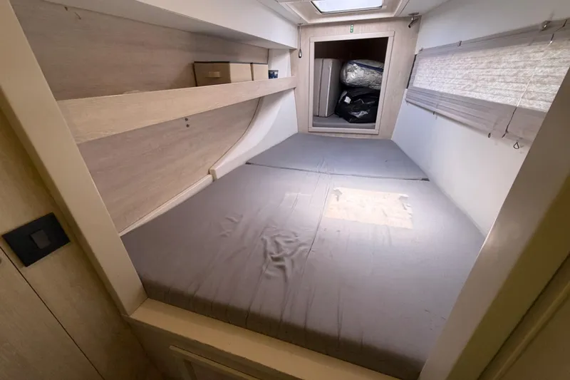 Slide: The Image of Interior cabin of a 2017 Leopard 40 catamaran with a cozy bed and storage space. - 111