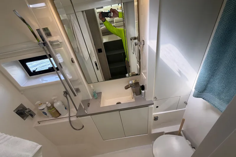Slide: The Image of Modern bathroom interior of a 2017 Leopard 40 yacht, featuring sleek fixtures and a window view. - 113