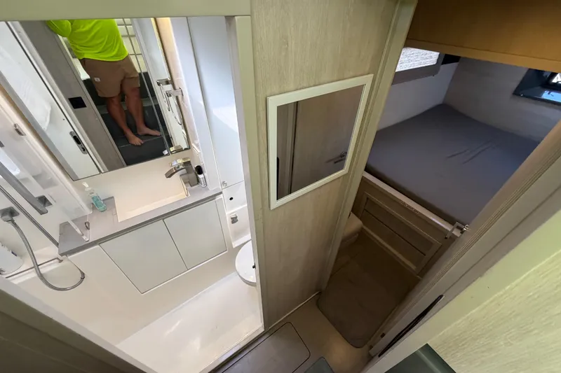 Slide: The Image of Interior of a 2017 Leopard 40 yacht featuring a compact bathroom and cozy sleeping area. - 114
