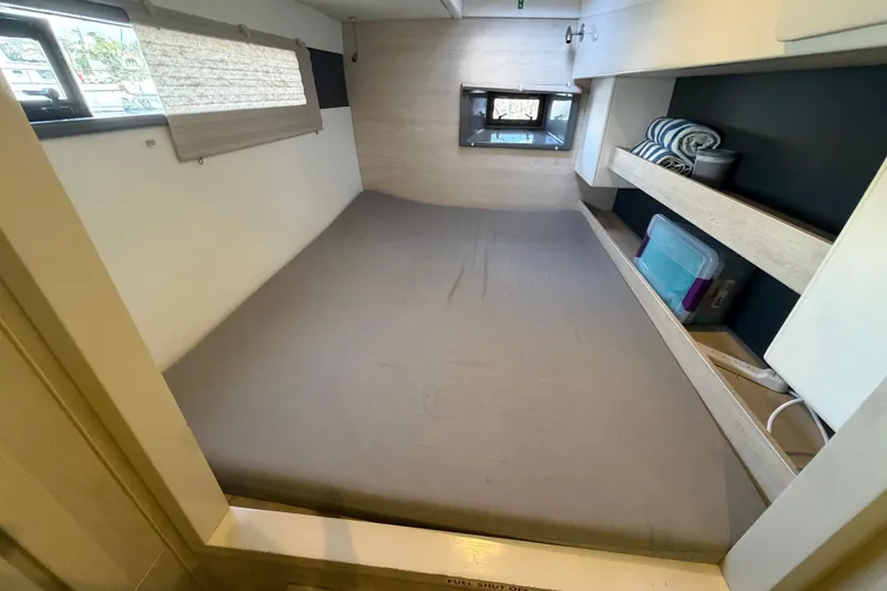 Slide: The Image of Interior cabin of a 2017 Leopard 40 catamaran with bed and storage shelves. - 115