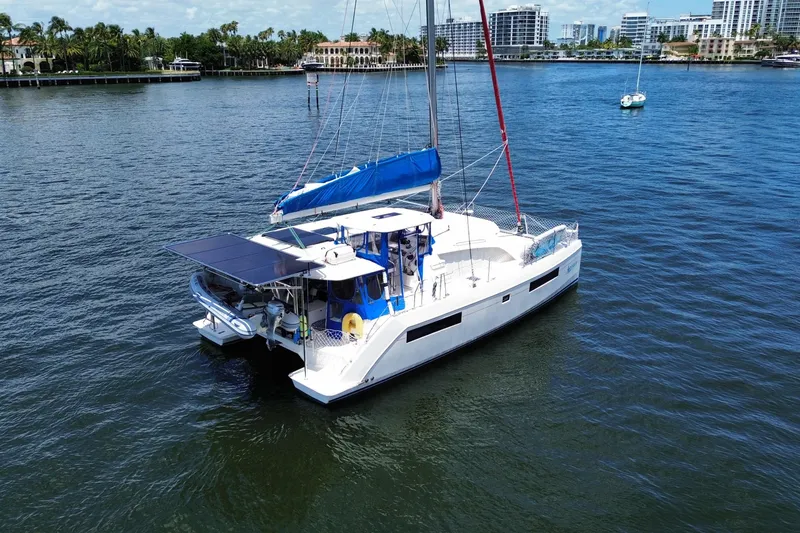 Slide: The Image of 2017 Leopard 40 catamaran sailing on calm waters near a coastal city. - 15