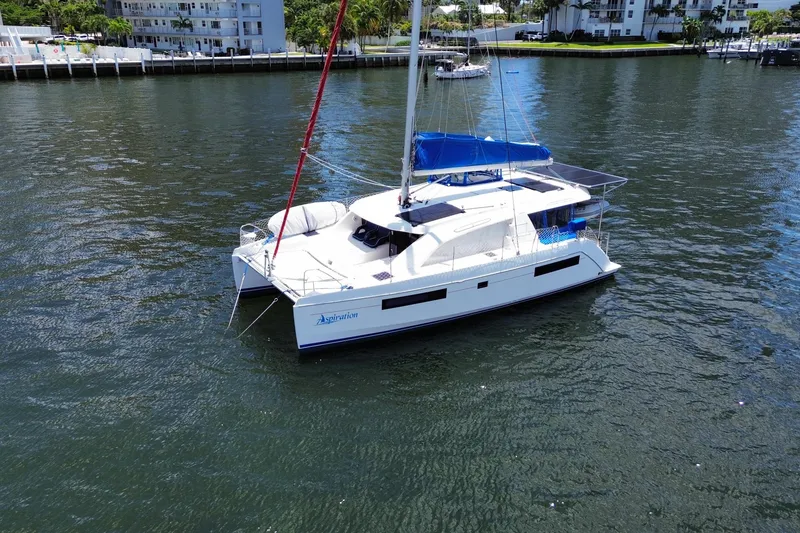 Slide: The Image of 2017 Leopard 40 catamaran sailing on calm waters near a marina. - 20