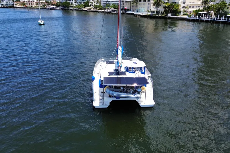 Slide: The Image of 2017 Leopard 40 catamaran sailing on calm waters near coastal buildings. - 24