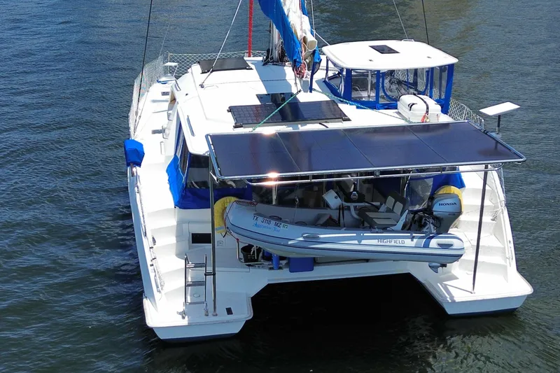 Slide: The Image of 2017 Leopard 40 catamaran with solar panels and dinghy on water. - 25