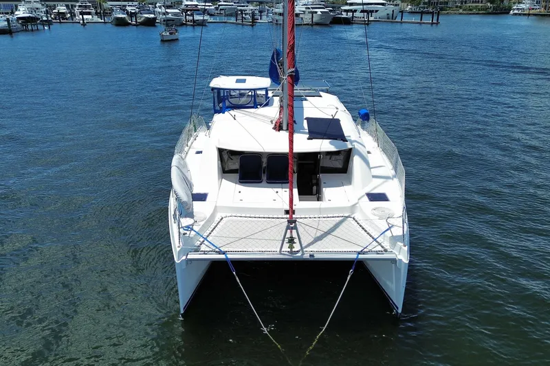 Slide: The Image of 2017 Leopard 40 catamaran docked in a marina, surrounded by water and other boats. - 30