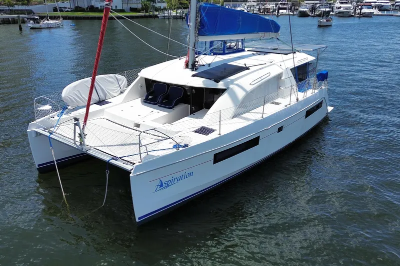 Slide: The Image of 2017 Leopard 40 catamaran with blue sail, docked in a marina. - 31