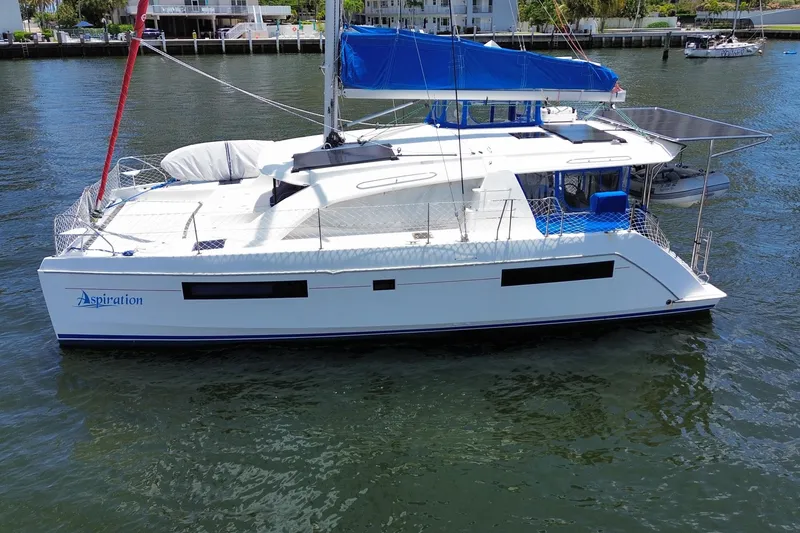 Slide: The Image of 2017 Leopard 40 catamaran with blue sail, docked in a marina. - 33