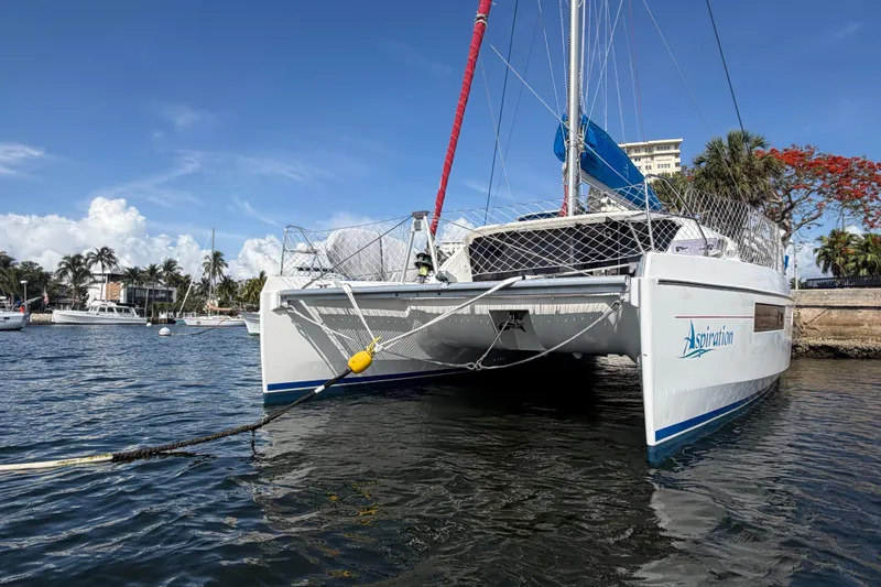 Slide: The Image of 2017 Leopard 40 catamaran docked in a scenic marina with clear blue skies. - 41
