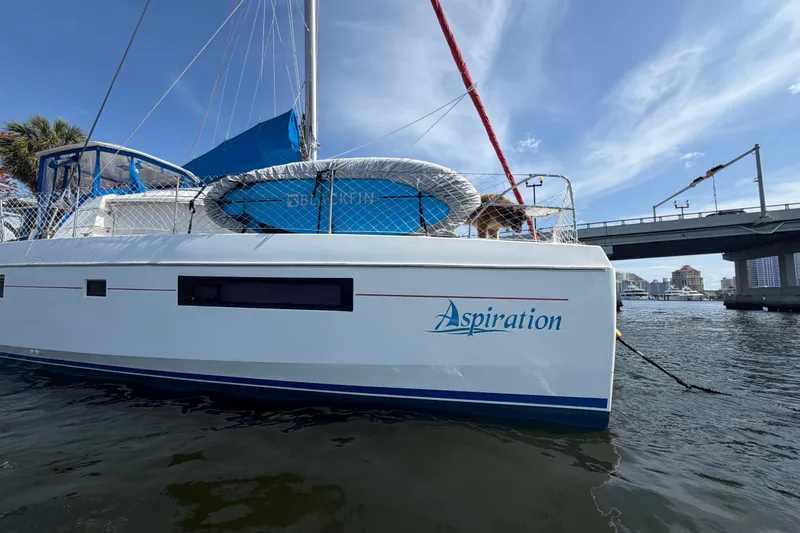 Slide: The Image of Leopard 40 catamaran named "Aspiration" docked near a bridge, 2017 model. - 44