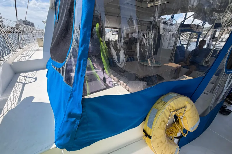 Slide: The Image of 2017 Leopard 40 catamaran with blue canopy and yellow life preserver on deck. - 46