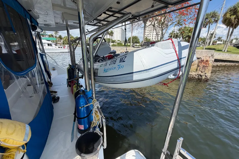 Slide: The Image of Leopard 40 catamaran with dinghy, docked by a scenic waterfront, 2017 model. - 47