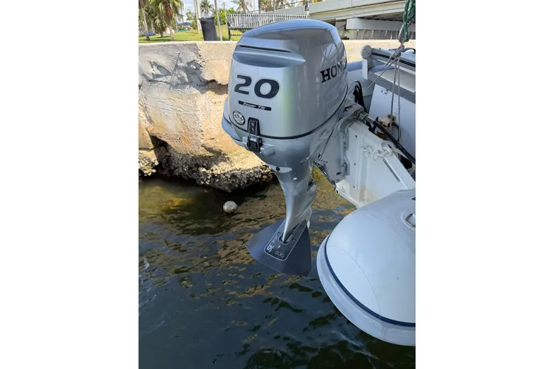 Slide: The Image of Honda 20 outboard motor on a 2017 Leopard 40 catamaran, docked by a stone wall. - 48