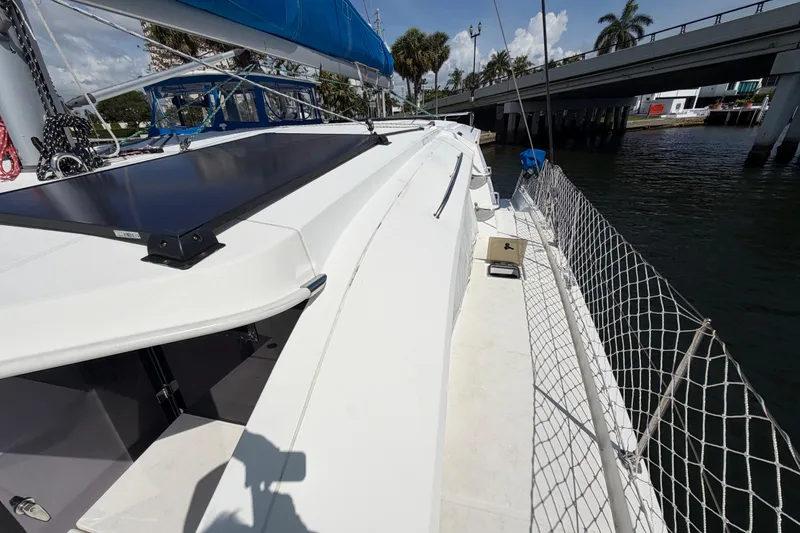 Slide: The Image of 2017 Leopard 40 catamaran deck with solar panel, docked near a bridge. - 51