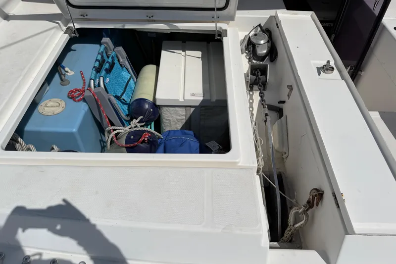 Slide: The Image of Storage compartment on a 2017 Leopard 40 boat, featuring ropes, fenders, and equipment. - 53