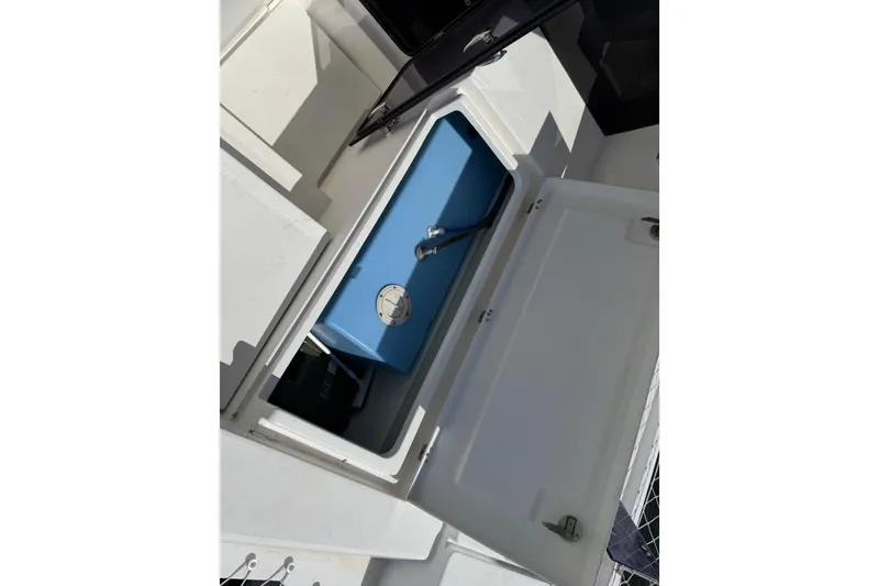 Slide: The Image of Storage compartment on a 2017 Leopard 40 boat, featuring a blue tank inside. - 54
