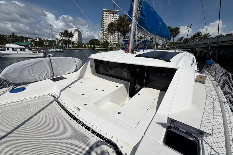 Slide: The Image of 2017 Leopard 40 catamaran docked in a marina with blue sails and sunny weather. - 56