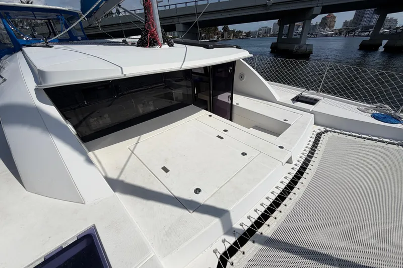 Slide: The Image of 2017 Leopard 40 catamaran deck with netting, docked near a bridge. - 57