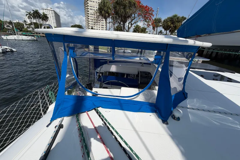 Slide: The Image of 2017 Leopard 40 catamaran with blue canopy, docked in a marina under a sunny sky. - 60