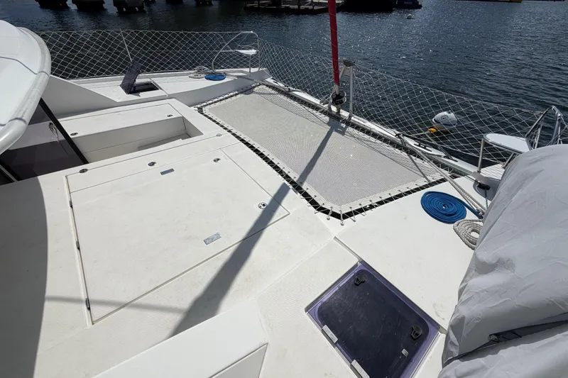 Slide: The Image of Deck view of a 2017 Leopard 40 catamaran, featuring netting and storage compartments. - 62