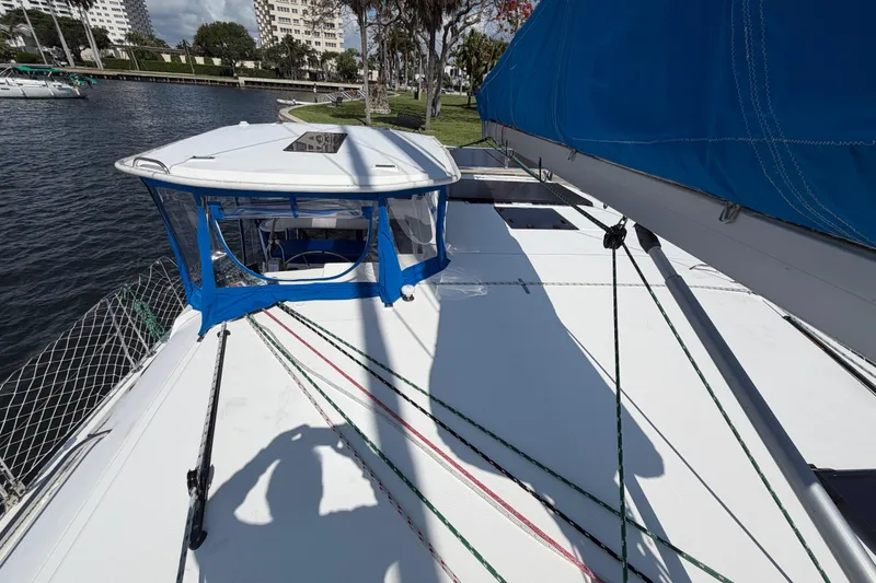 Slide: The Image of 2017 Leopard 40 catamaran deck with blue canopy, docked by waterfront. - 66