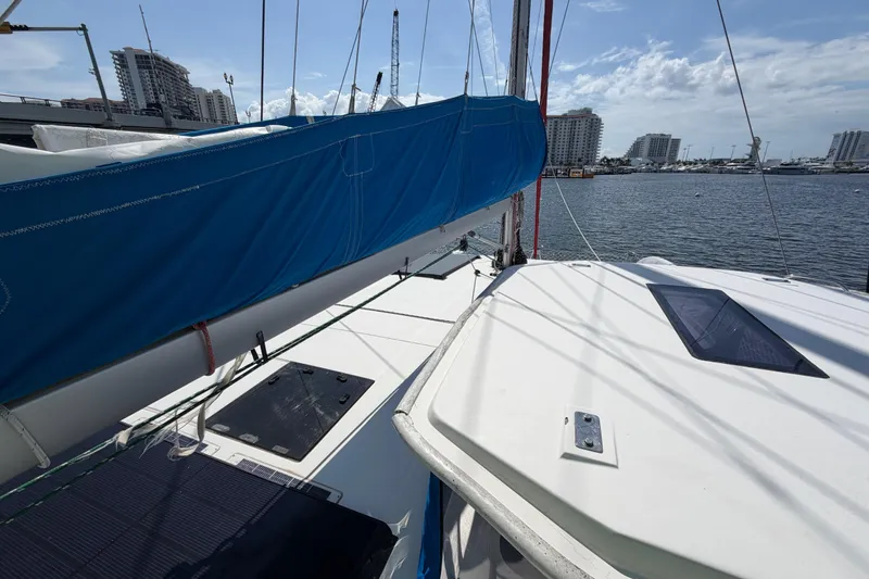 Slide: The Image of 2017 Leopard 40 catamaran with blue sail cover docked in a marina. - 67